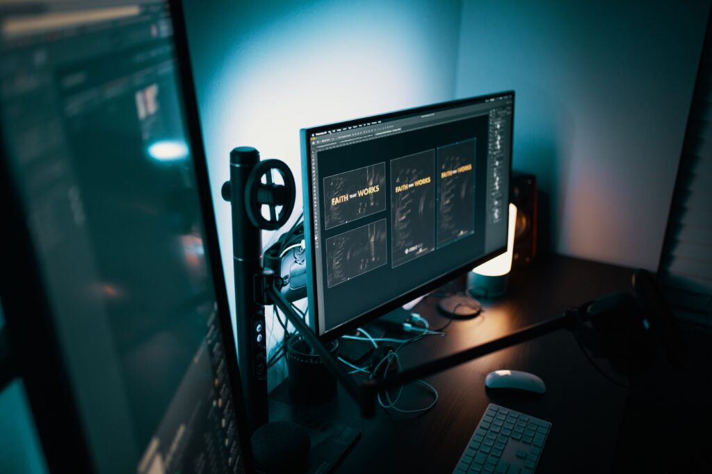 How Matte Screen Protectors Stop Office Eye Strain A stylish modern workspace with dual monitors displaying design software in a dimly lit room.