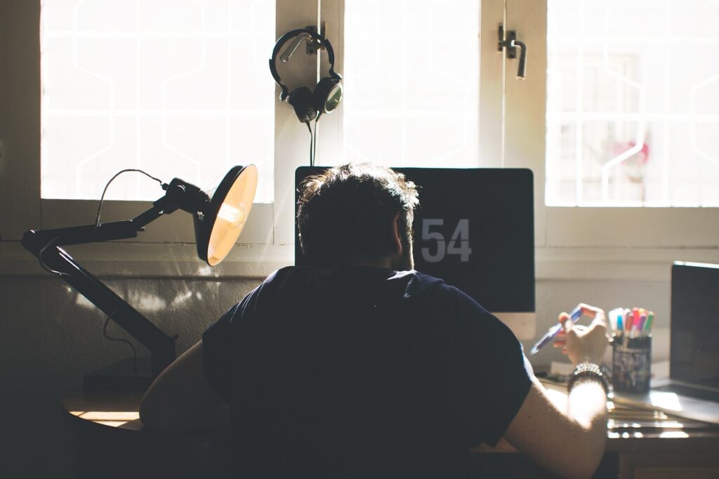 Why Under-Desk Footrests Stop Daily Back Pain man, chair, computer, desk, sit, seated, electronics, indoors, lamp, laptop, room, workspace, home office, work from home, computer, desk, laptop, room, home office, home office, home office, home office, home office